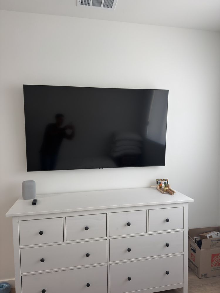TV mounted above a media console